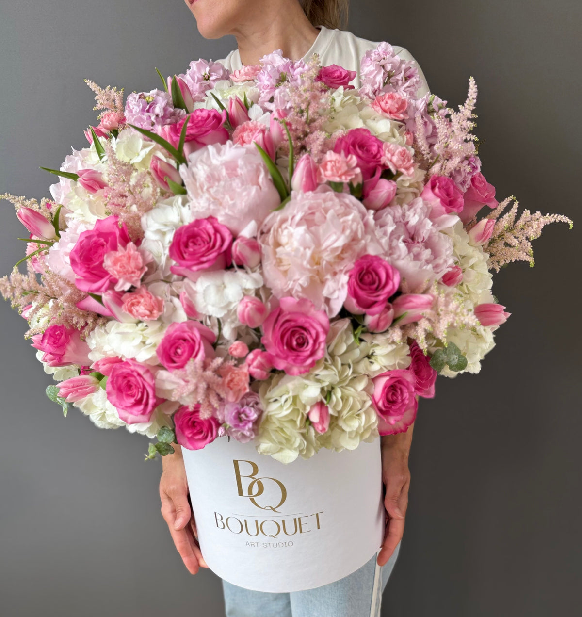 Close-up of pink roses and hydrangeas tulips in a luxury flower box.