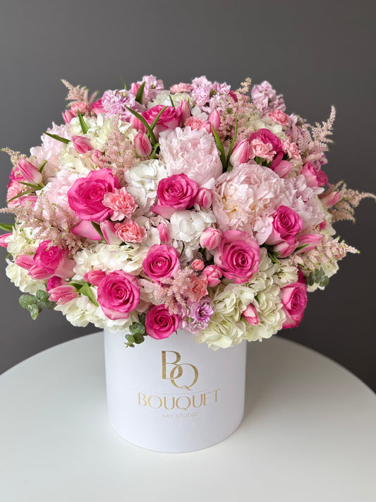Top view of a pink roses and hydrangeas tulips flower box.